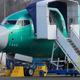 A worker walks past a Boeing 737 MAX 8 airplane being built for American Airlines at Boeing Co.’s Renton assembly plant, Wednesday, March 13, 2019, in Renton, Wash.